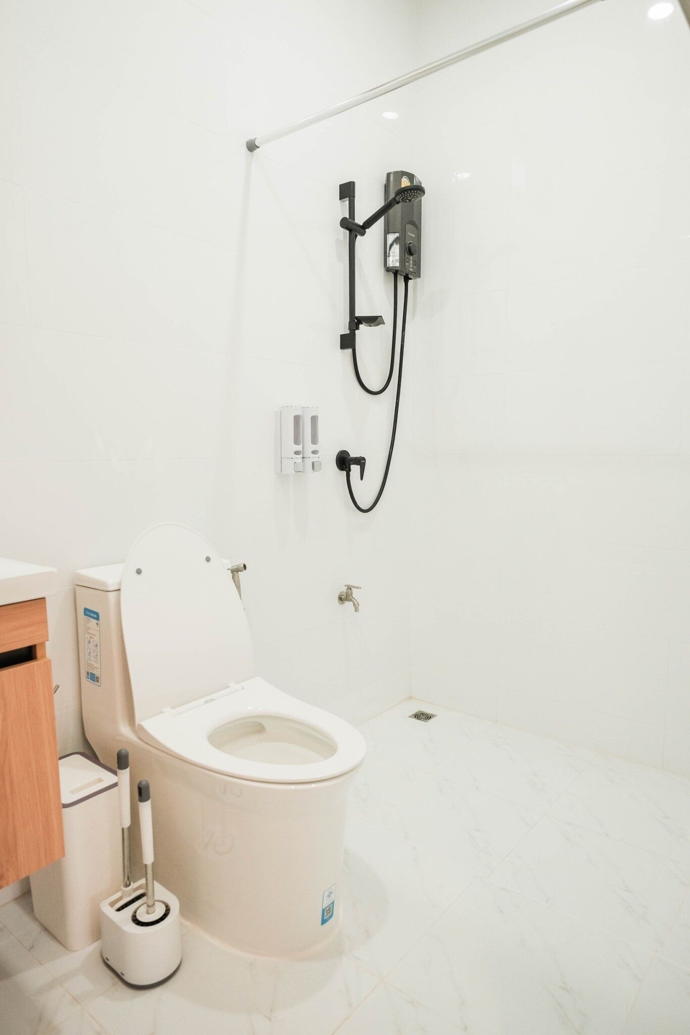 A modern bathroom with a toilet, bidet, and shower.