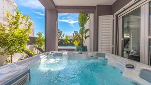 A hot tub with a clear view of the pool and surrounding greenery. - Luxurious home in Biograd (Biograd)