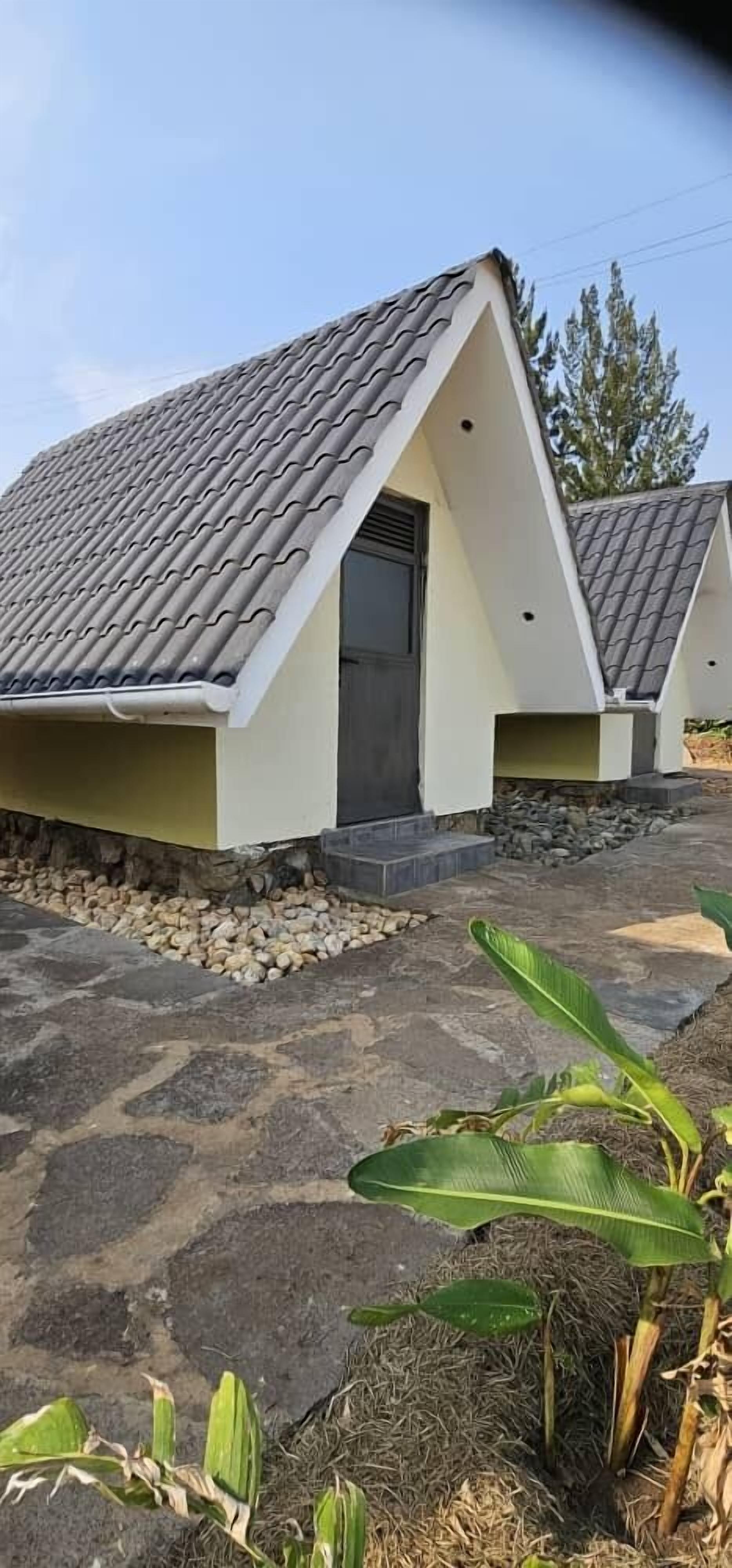 A modern building with a sloped roof and a small entrance.