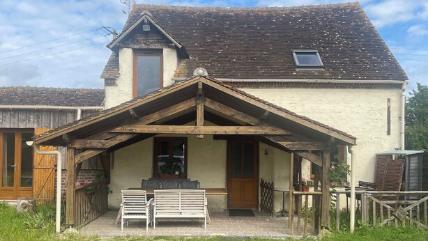 A rustic house with a wooden porch, a small window, and a door. - Grand Gîte (Savigny-sur-Braye)