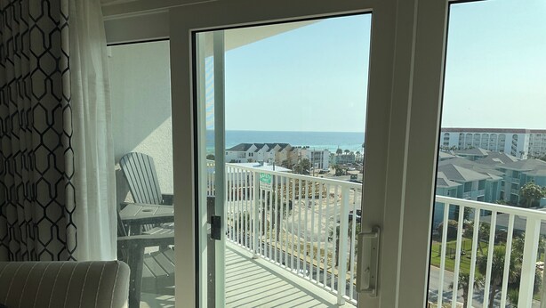 A balcony with a view of the ocean and a residential area. - 7th Floor Beachfront Complex 2 BR 2B Beautifully furnished wFree Beach Service  (Fort Walton Beach)