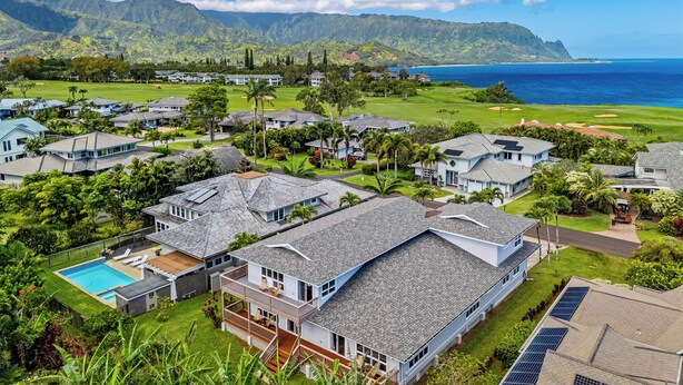 A coastal residential area with houses, a golf course, and a clear view of the ocean. - 4Br 4.5 Ba Punahele House with Ocean and Mountain Views, Beach Gear, Near Queens Pond (Princeville)