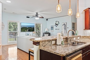 Enjoy meals in this well-equipped kitchen with a dishwasher, stainless steel sink, and ample counter space.