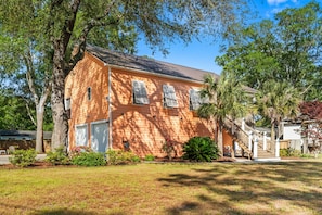 Stunning two-story residence with a central entrance and beautifully manicured grounds.