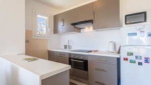 Una cocina moderna con horno empotrado, microondas y refrigerador.