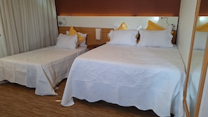 A hotel room with two beds, each with white bedding and decorative pillows. - HOTEL FARIA LIMA (São Paulo)