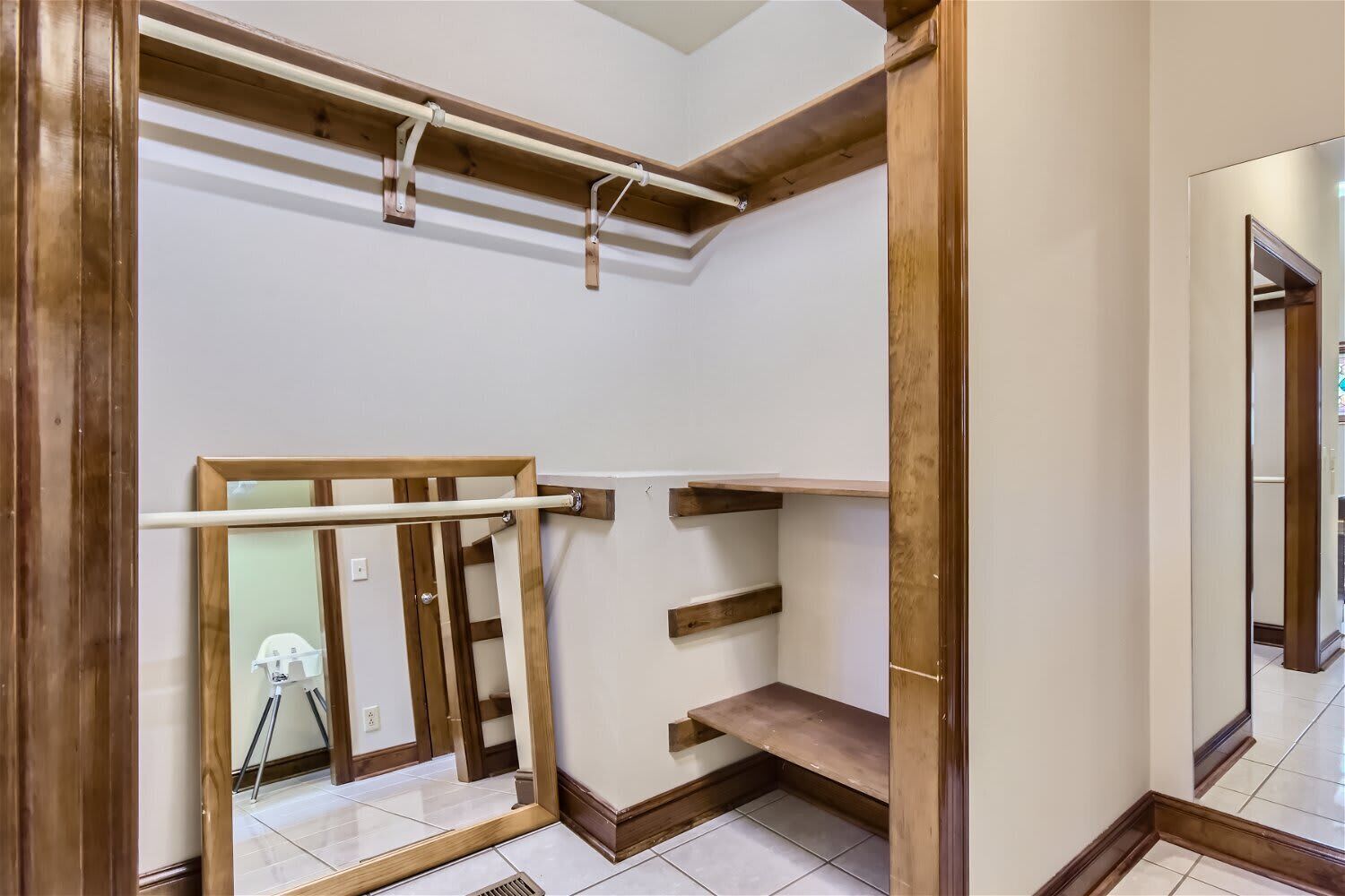 A room with wooden beams, a metal rod, and a wooden ladder.