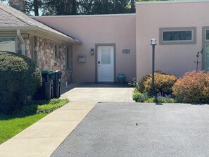 A two-story building with a stone facade, a front door, and a mailbox.