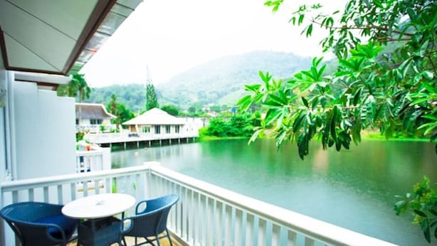 A balcony with a view of a lake and mountains.
