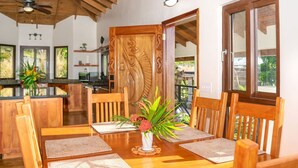 A dining area with a wooden table, chairs, and a decorative centerpiece.
