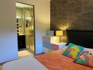 A bedroom with a bed, a nightstand, a lamp, and a mirror. - Price drop magnificent villa in a quiet area with swimming pool and lake view (Annecy)