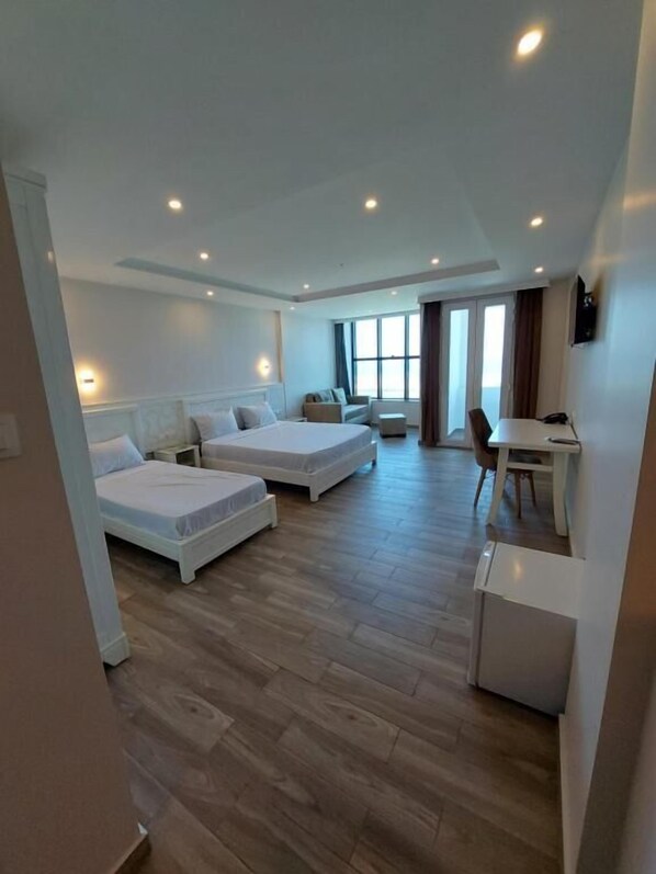 Habitación triple familiar, vista al mar | Minibar, escritorio, cortinas blackout y insonorización 