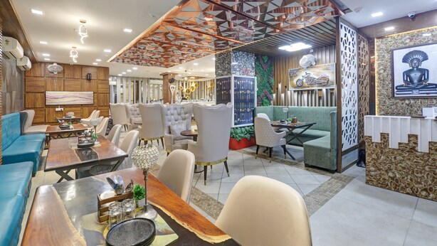 A modern hotel lobby with a variety of seating options, including sofas, chairs, and a dining area.