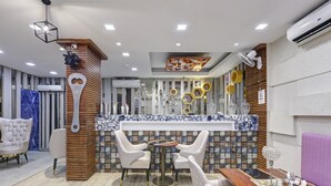 A modern interior with a bar area, seating, and decorative elements.