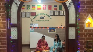 An archway entrance with a sign reading "The Sparkling Turtle Backpackers Hostel" and flags. - The Sparkling Turtle Backpackers Hostel (Nagarjun)