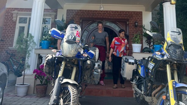 The entrance of The Sparkling Turtle Backpackers Hostel with a signboard, a brick facade, and several motorcycles parked outside. - The Sparkling Turtle Backpackers Hostel (Nagarjun)