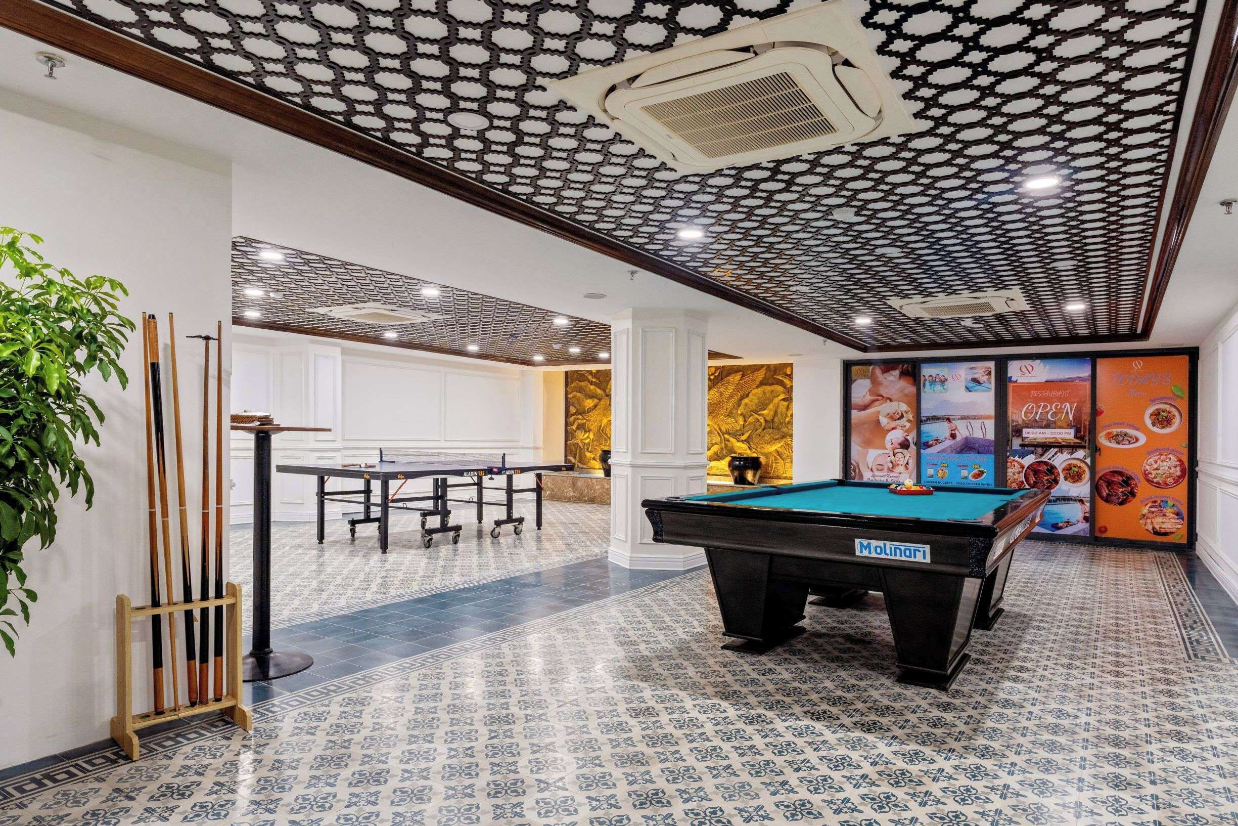 A billiards room with a pool table, cue rack, and a table tennis table.