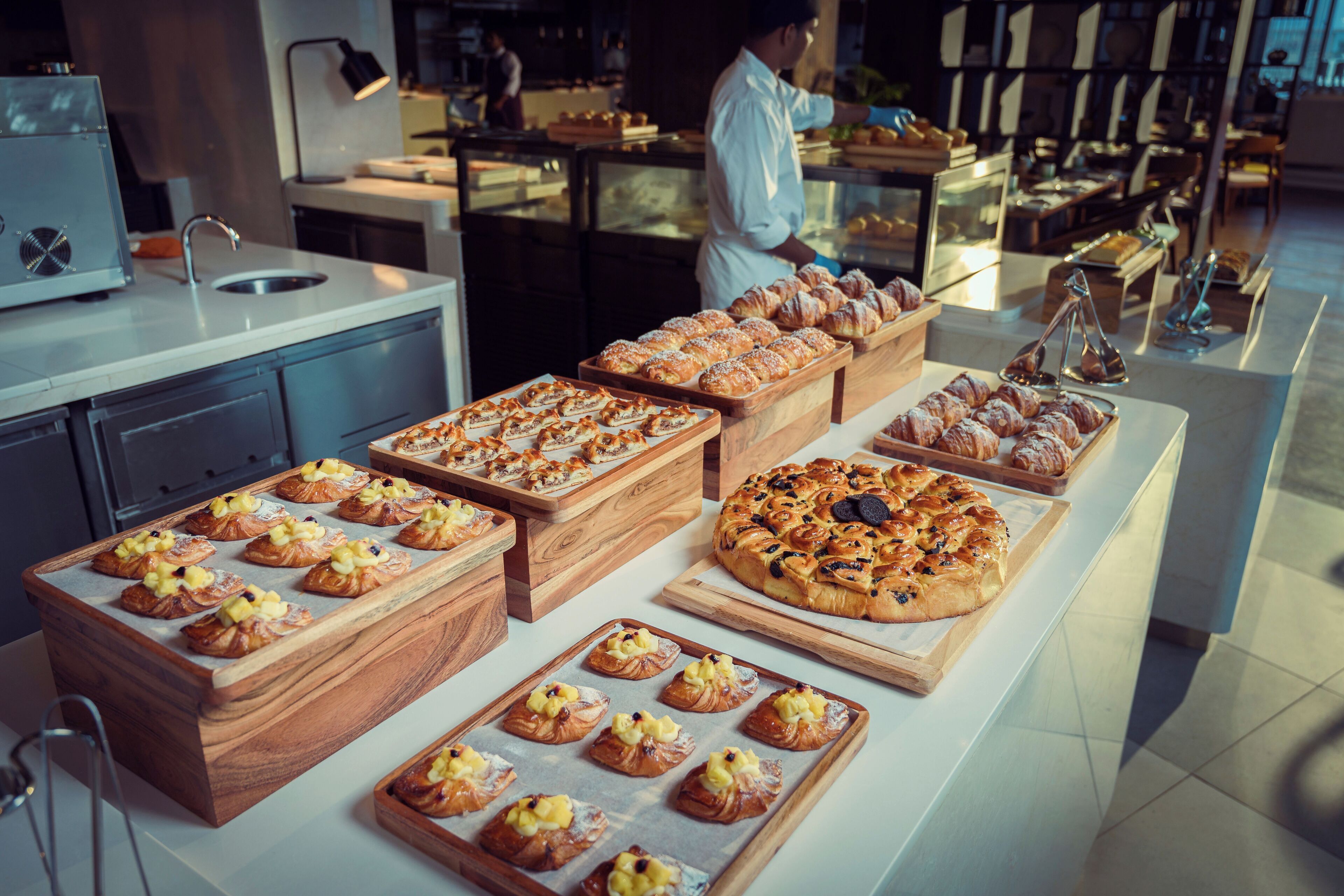 A bakery display with various pastries and bread.