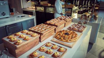 A bakery display with various pastries and bread.