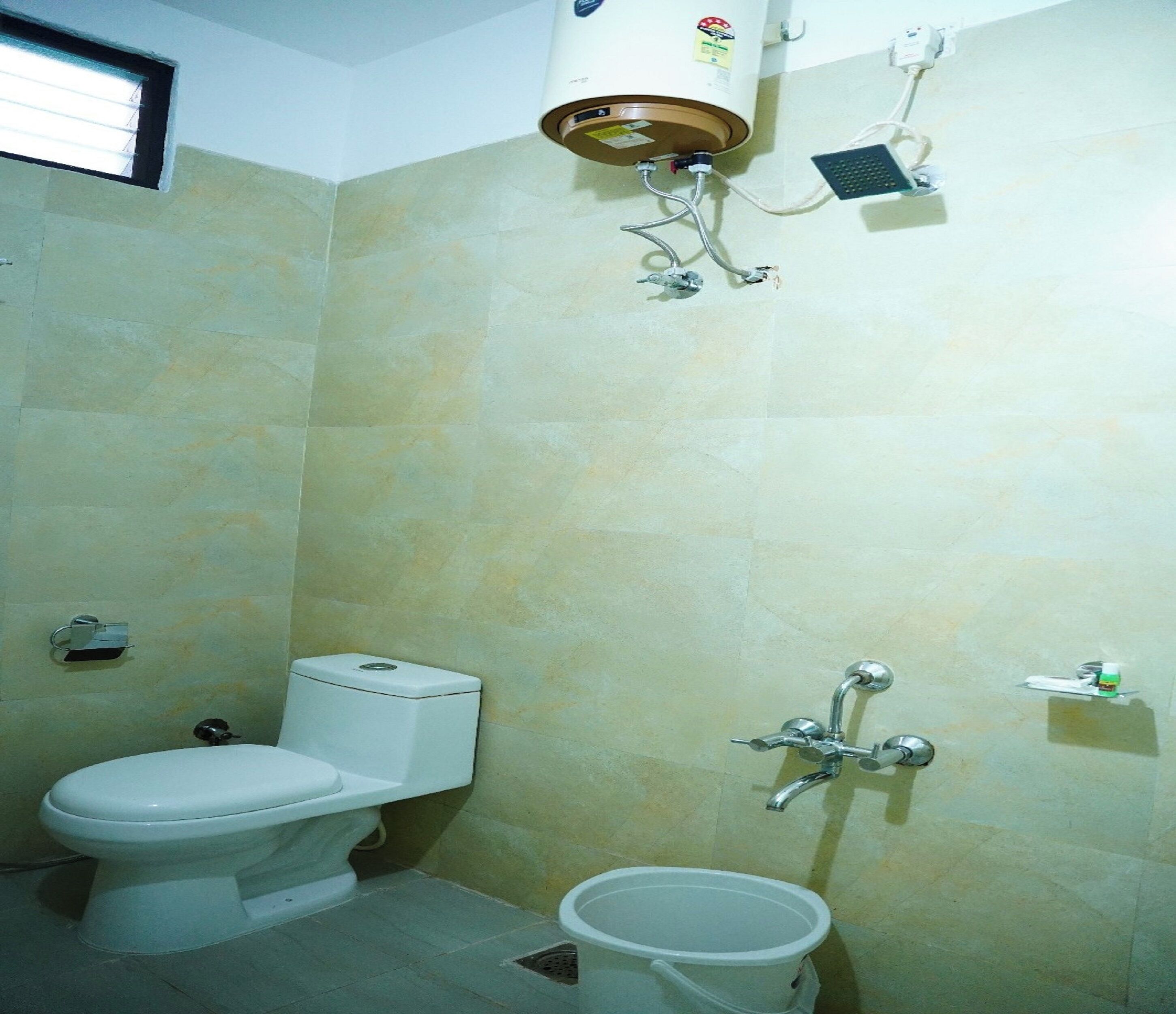 A small bathroom with a toilet, a bidet, and a shower.