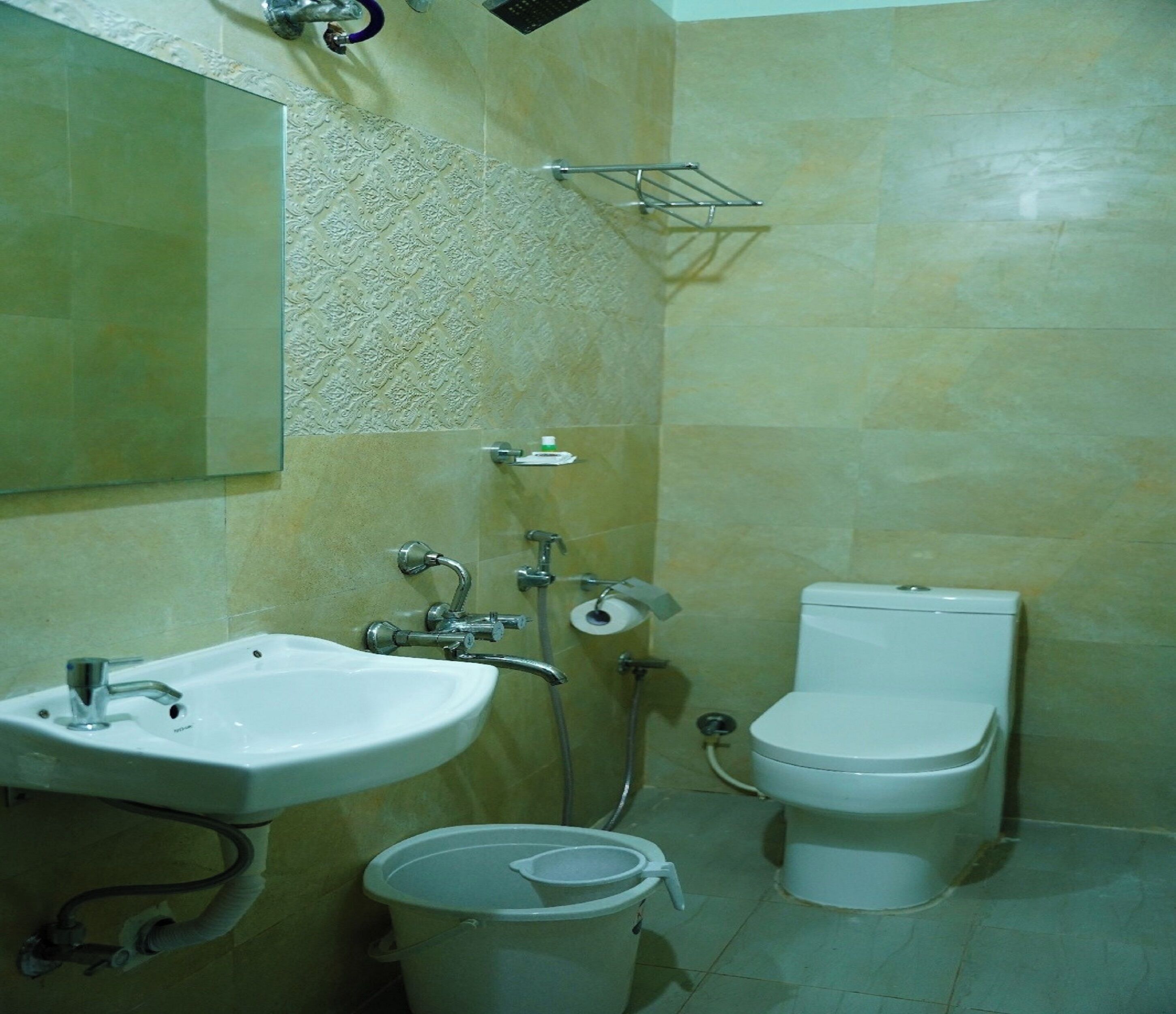 A bathroom with a sink, toilet, and shower.