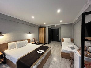 A hotel room with two beds, a wardrobe, a desk, and a chair. - Saffron Hotel Old City (Istanbul)