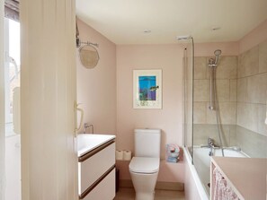 A bathroom with a toilet, sink, and shower.