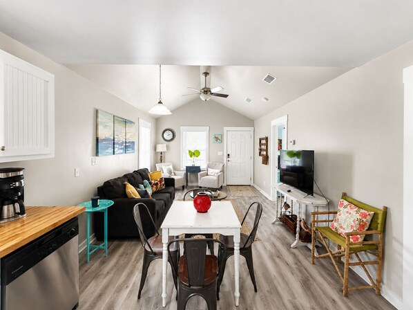 A compact living space with a dining area, kitchen, and seating area.