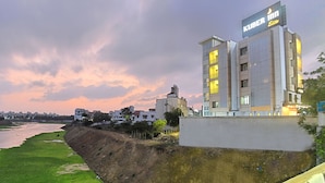 Un hôtel avec une enseigne indiquant « KUBER Elite » et présentant un design architectural moderne.