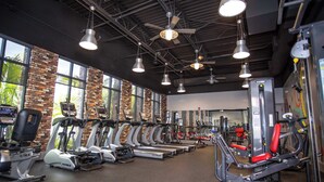 A gym with treadmills, ellipticals, and weight machines.