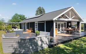 Relax and socialize in this spacious deck with a fire pit and pergola.