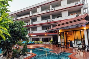 A hotel with a rooftop pool area, multiple balconies, and outdoor seating. - Gazebo Resort Pattaya (Pattaya)