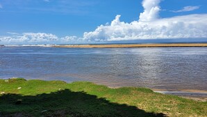 A beach with a grassy foreground and a sandy shore. - Villa Inlet Galle (Galle)