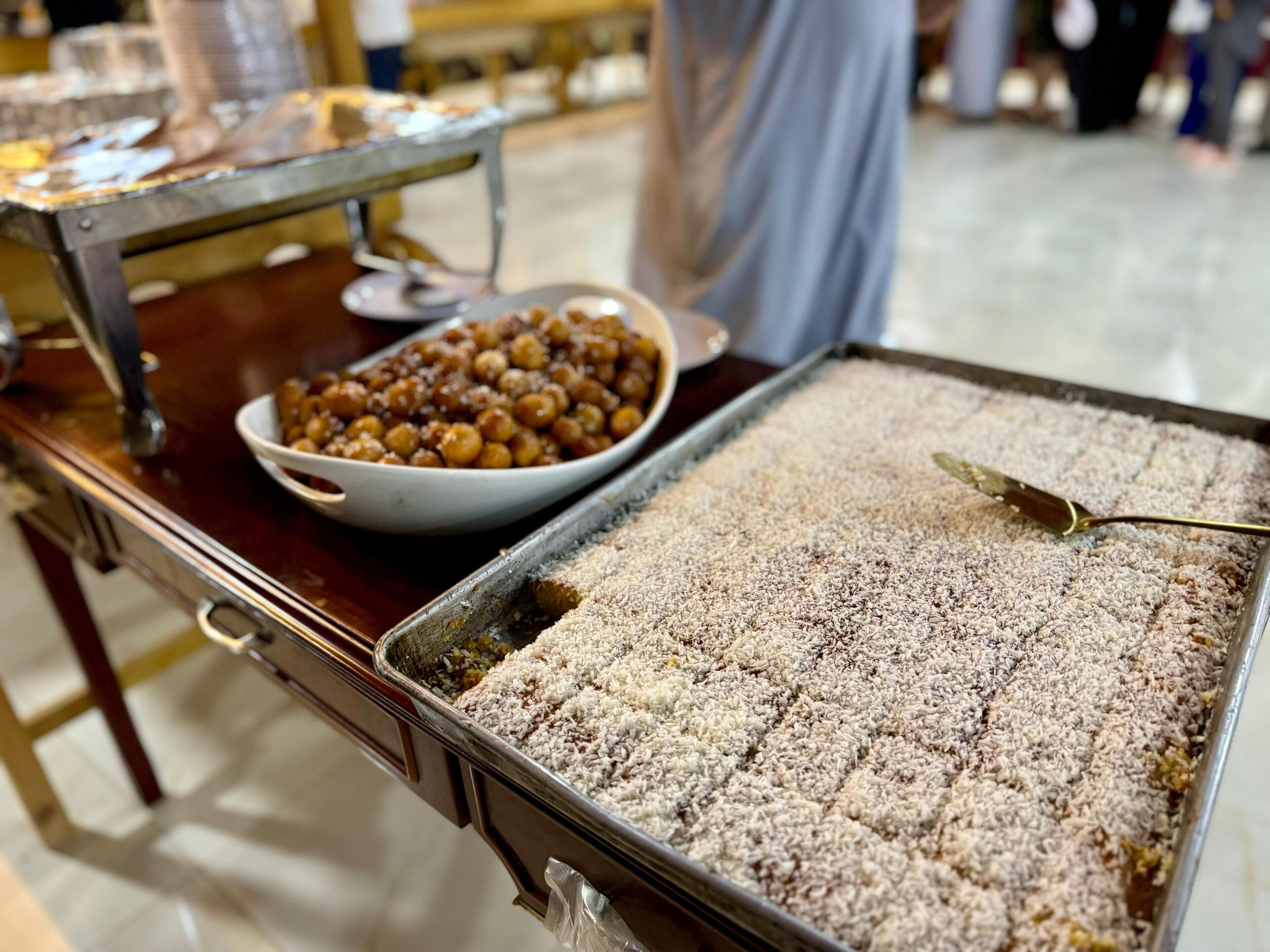 En buffetbord med et fad baklava og en skål nødder.