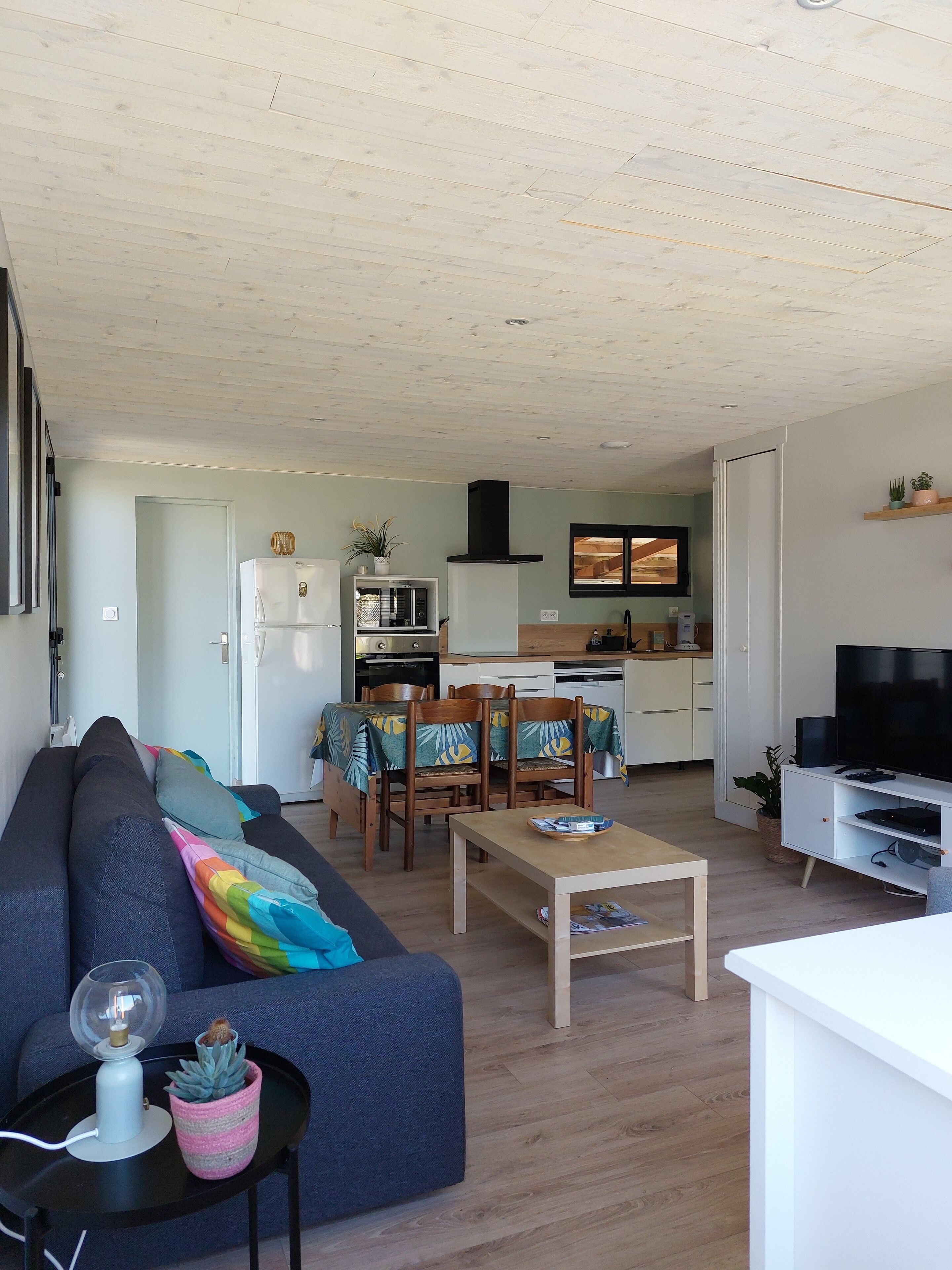 A modern living room with a sofa, a coffee table, and a TV stand.