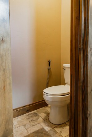 A bathroom with a toilet, a shower, and a tiled floor. - Luxury villa w/ lake+mtn views+private theatre! (Grand Lake)