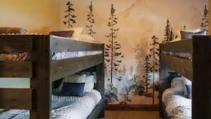 A room with two bunk beds, a wall mural of trees, and a wooden floor. - Luxury villa w/ lake+mtn views+private theatre! (Grand Lake)