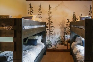 A room with two bunk beds, a wall mural of trees, and a wooden floor. - Luxury villa w/ lake+mtn views+private theatre! (Grand Lake)
