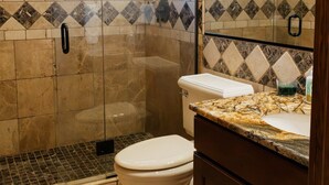 A bathroom with a shower, toilet, and vanity. - Luxury villa w/ lake+mtn views+private theatre! (Grand Lake)