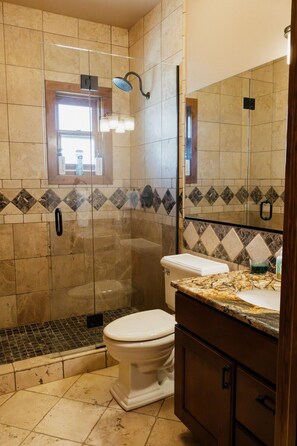 A bathroom with a shower, toilet, and vanity. - Luxury villa w/ lake+mtn views+private theatre! (Grand Lake)