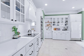 Enjoy cooking in this well-equipped kitchen with an oven, refrigerator, and ample countertop space.