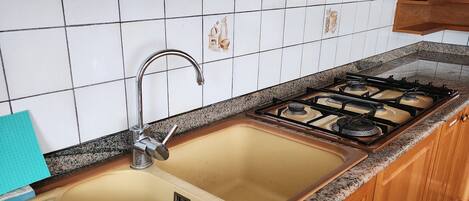 Fridge, microwave, stovetop, coffee/tea maker