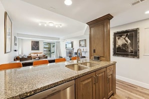 A kitchen with granite countertops, stainless steel appliances, and wooden cabinets.