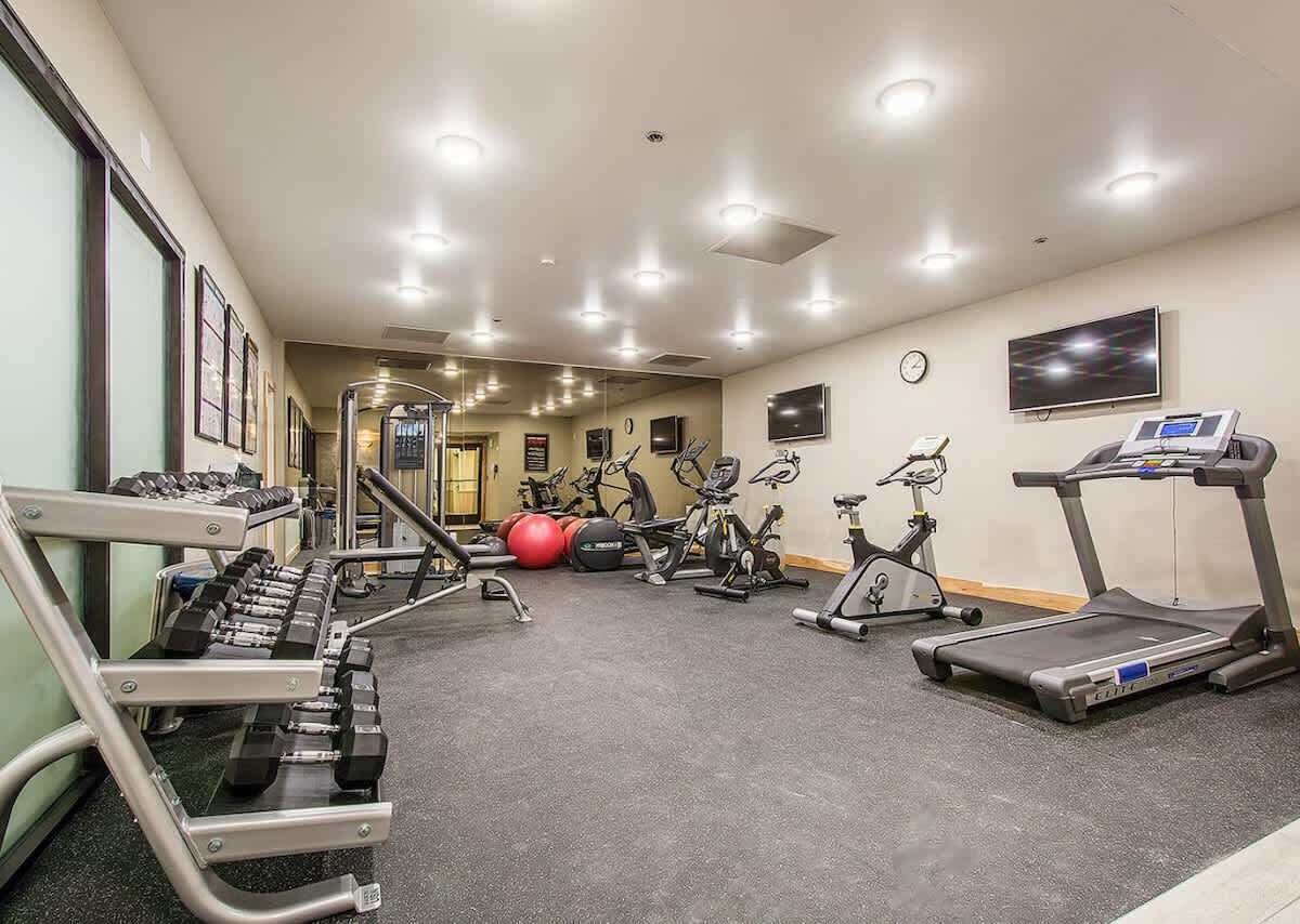 A gym with treadmills, stationary bikes, and weight machines.