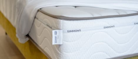 A mattress with the brand name 'Simmons' visible on it.
