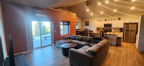 A modern living room with a sectional sofa, a dining area, and a kitchen with white cabinets and stainless steel appliances. - Cozy home with amazing views, close to Discovery Ski Area.

Pet Friendly
 (Anaconda)
