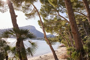 On the beach, white sand, sun loungers, beach umbrellas