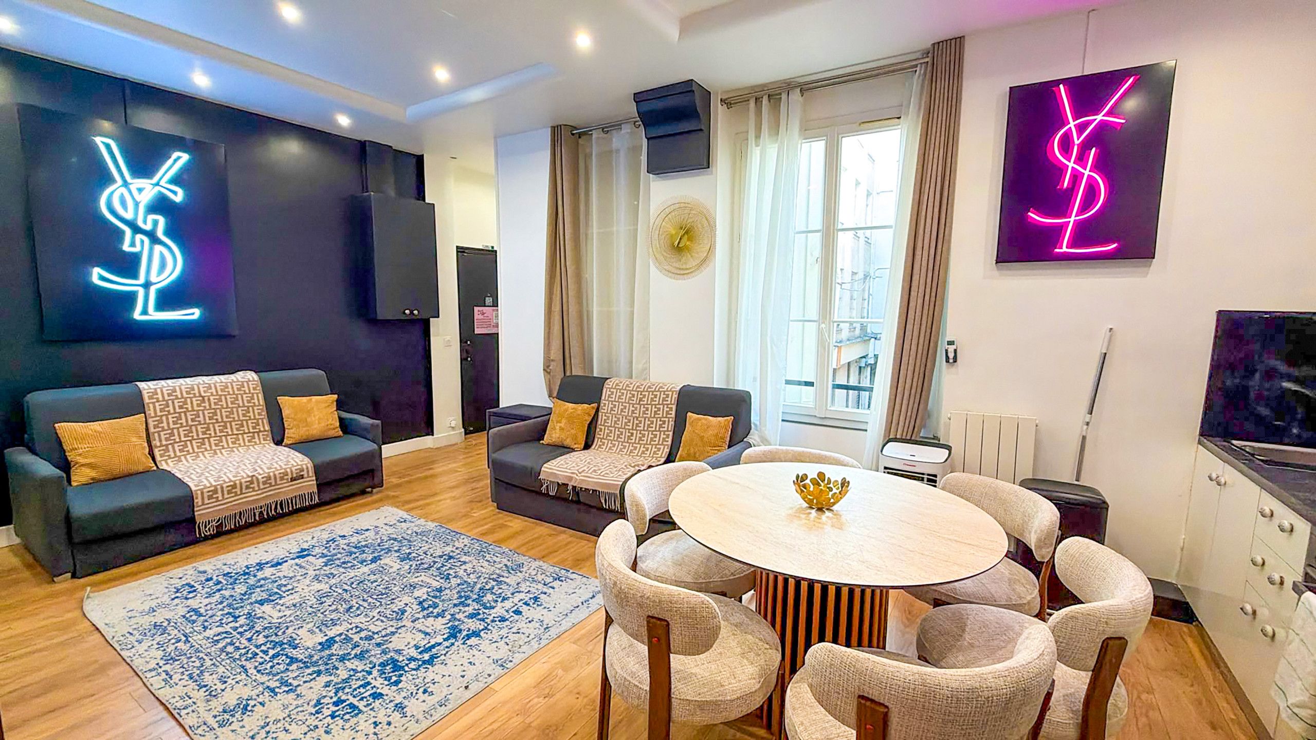 A modern living room with a sofa set, a coffee table, and a TV.