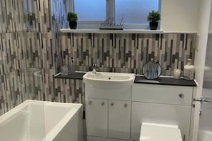 Combined shower/bathtub, deep-soaking bathtub, towels