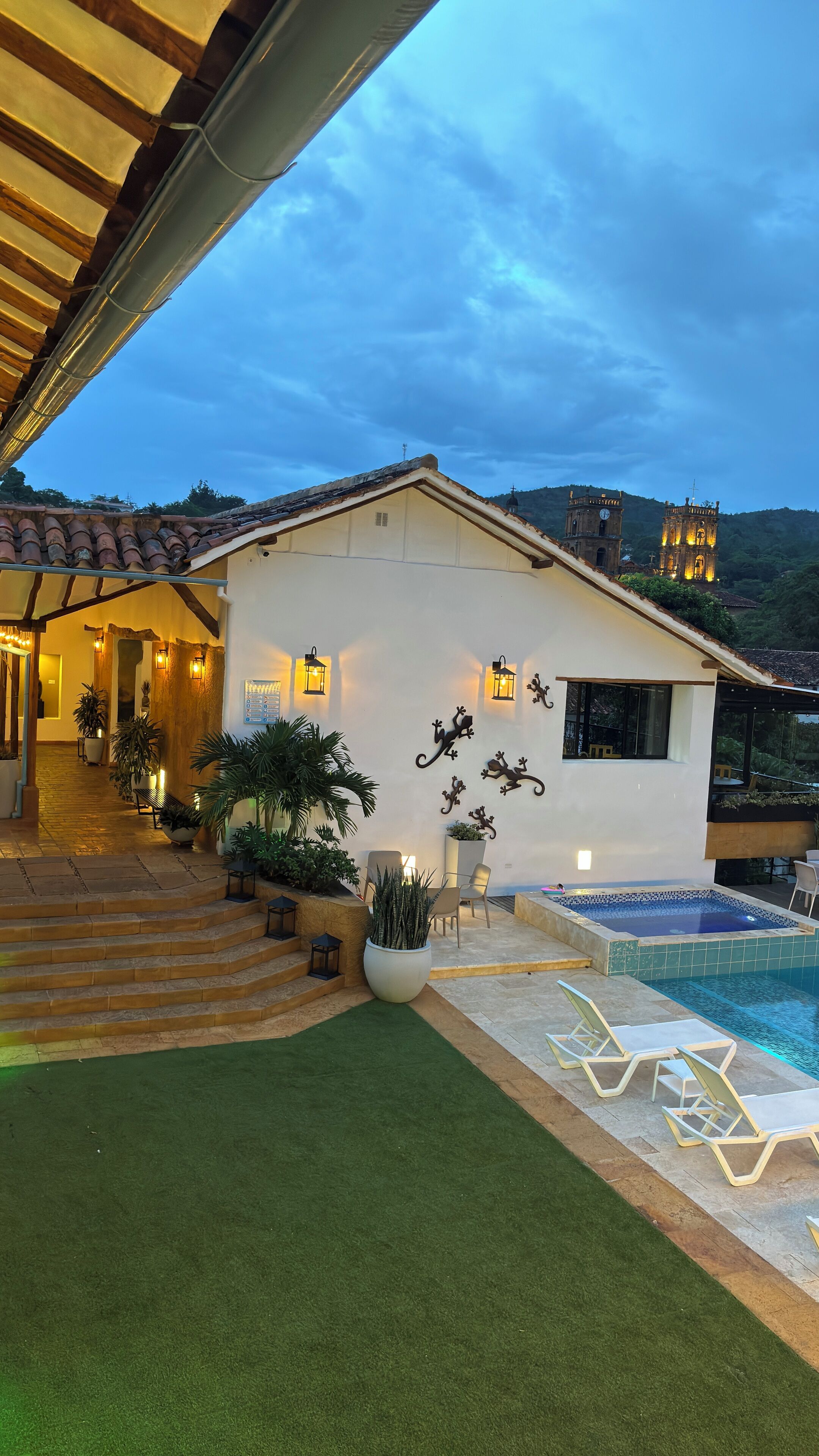 A modern house with a swimming pool, outdoor seating, and a well-maintained garden.